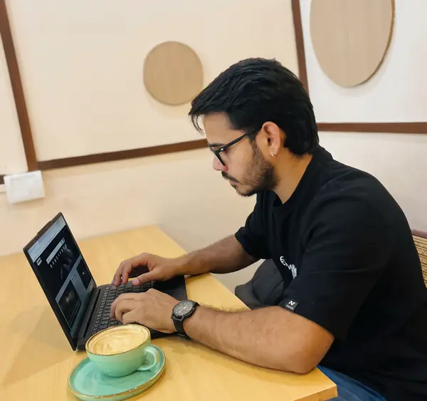 Yatharth working on a laptop in a café